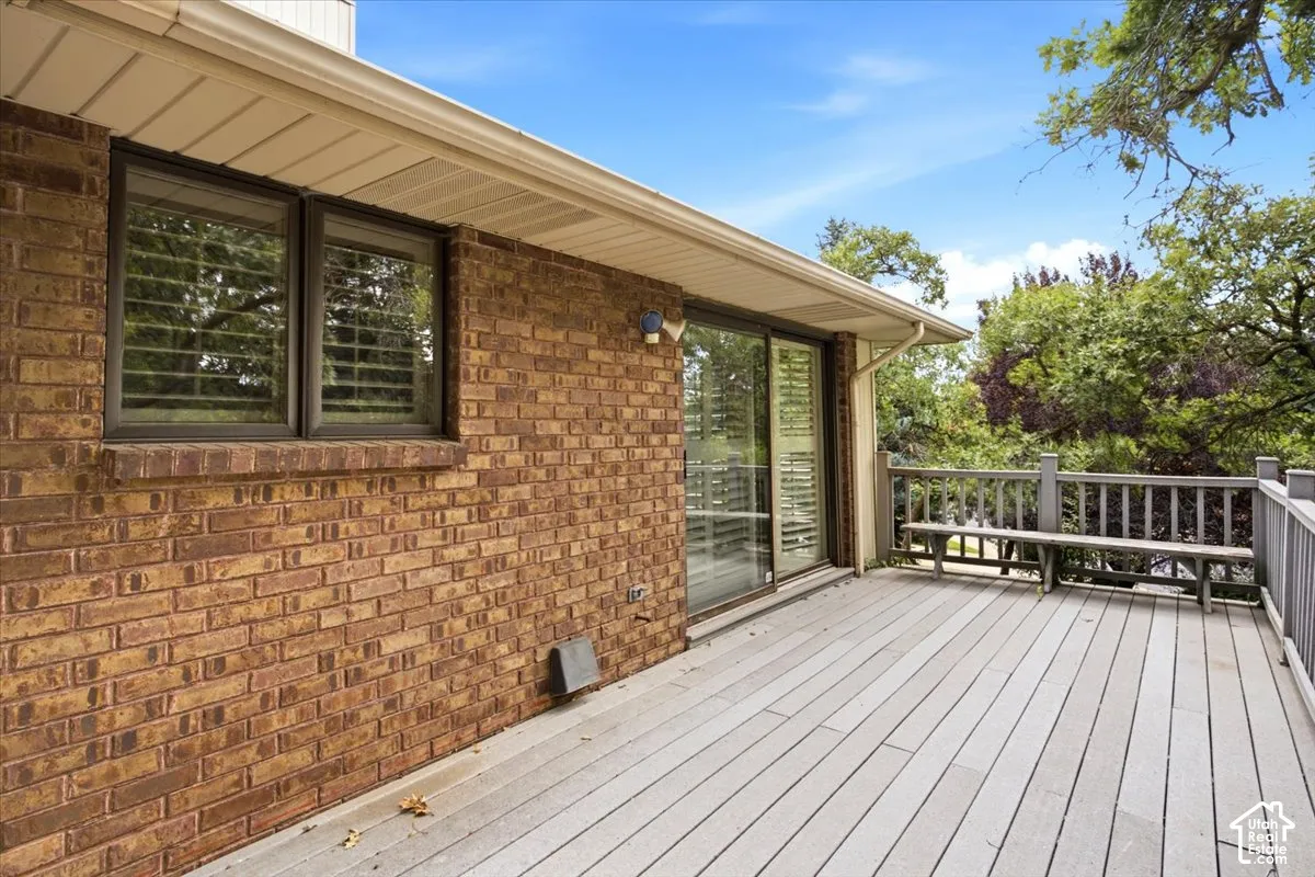 Expansive deck with composite decking, perimeter railing, and integrated wood bench seating