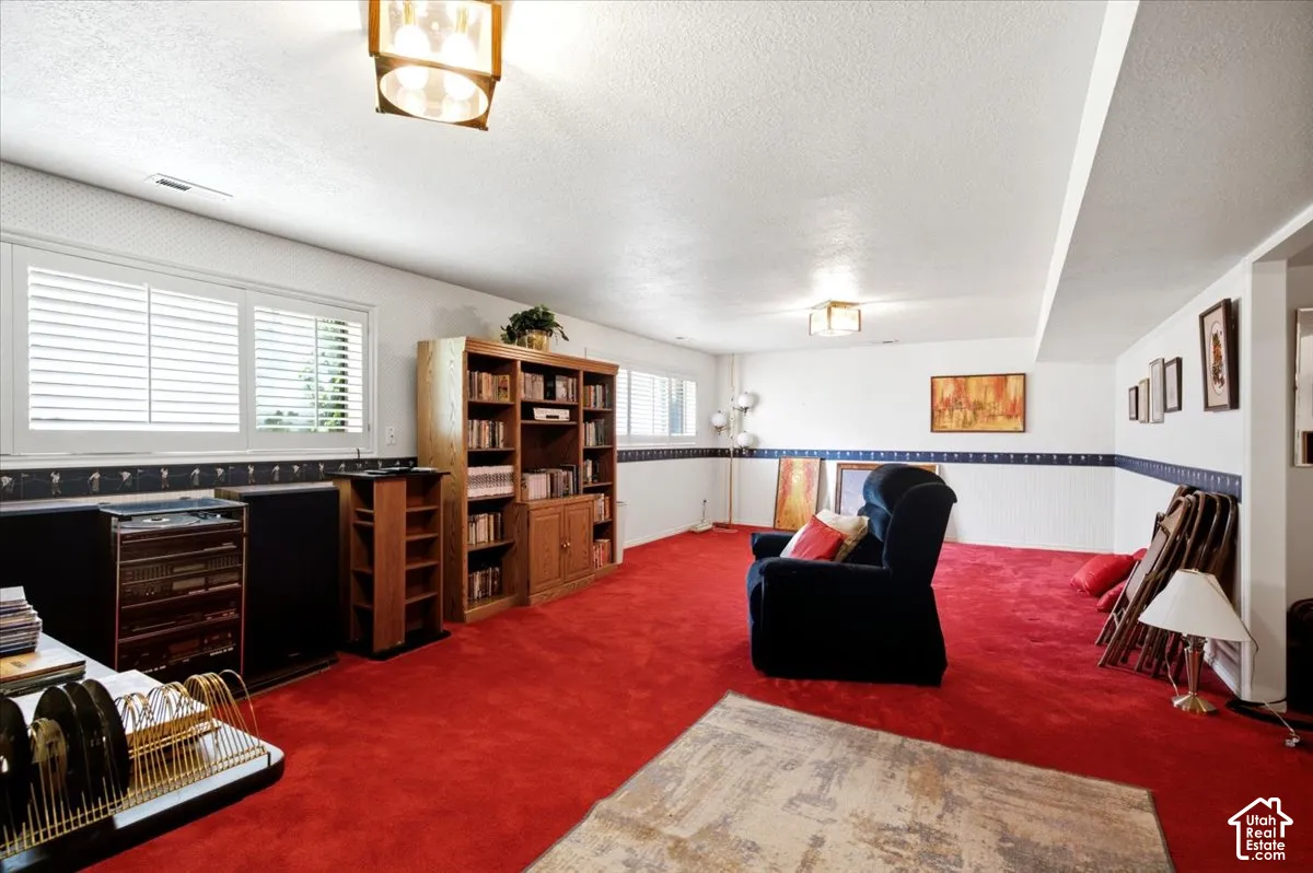 Plush red carpeting and white walls define this expansive interior space