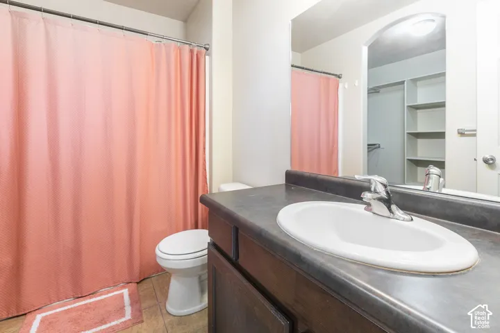 Vanity with an integrated sink, polished chrome faucet, and dark-finish cabinetry