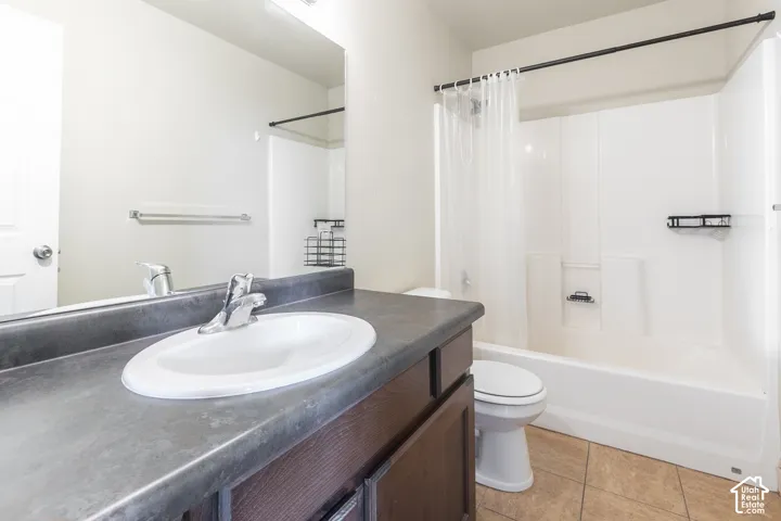 Integrated vanity with a white oval sink, dark countertop, and chrome faucet