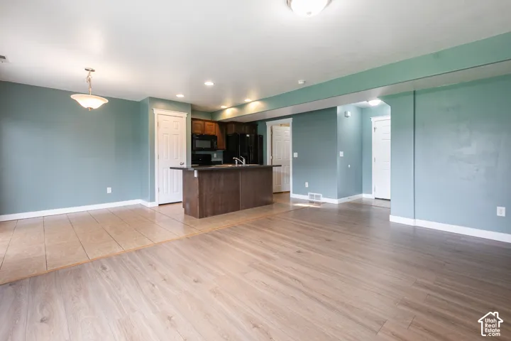 Open concept living area featuring wood-finish flooring and a kitchen island