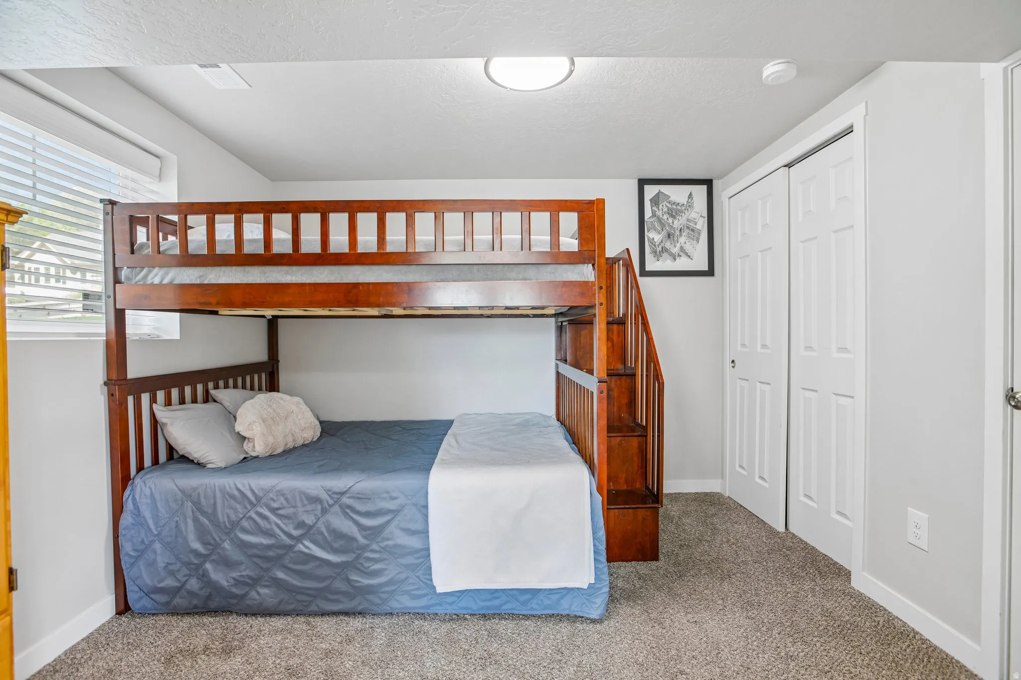 Plush carpet flooring, light gray wall paint, white trim, recessed lighting, and a window with blinds