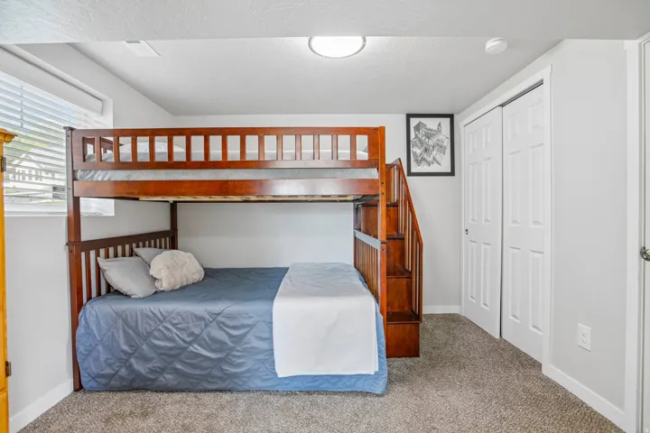 Plush carpet flooring, light gray wall paint, white trim, recessed lighting, and a window with blinds