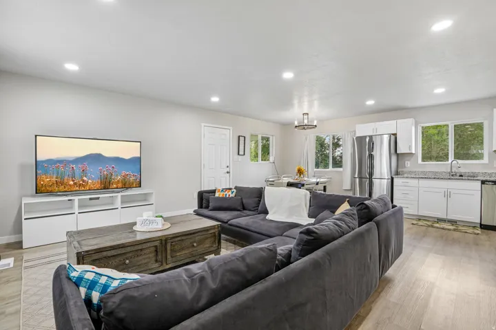 Open concept living area with wood-finish flooring