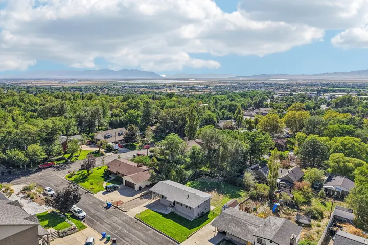 Expansive suburban setting with mature trees and mountain scenery