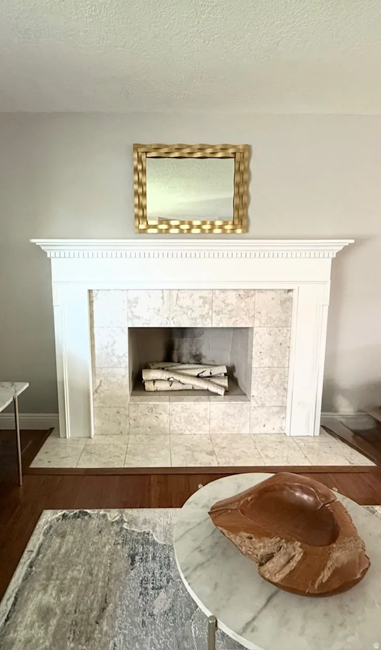Fireplace with a white mantel, tile surround, and an integrated firebox