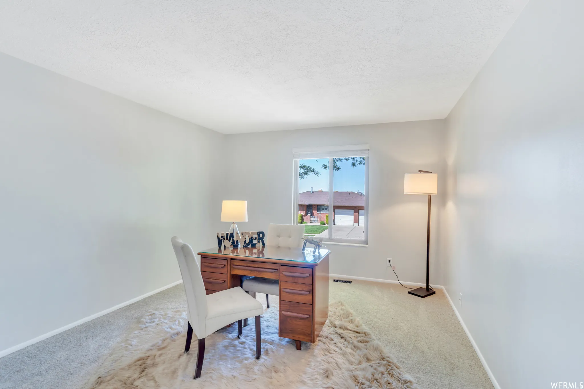Soft gray walls with light-toned carpeting