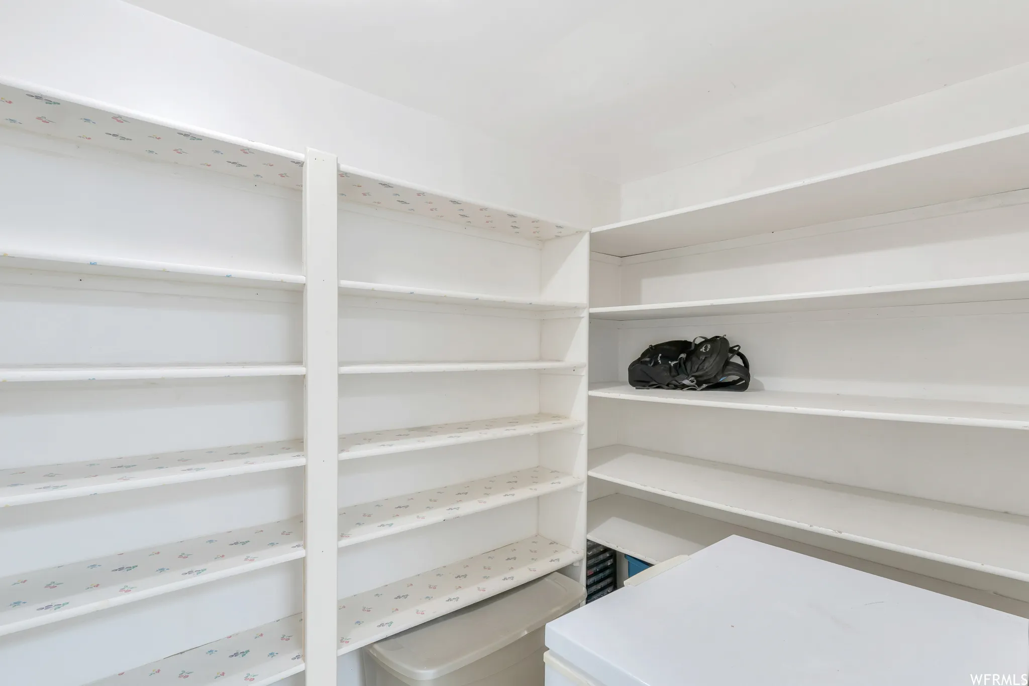 White shelving system with multiple tiers, offering extensive storage capacity