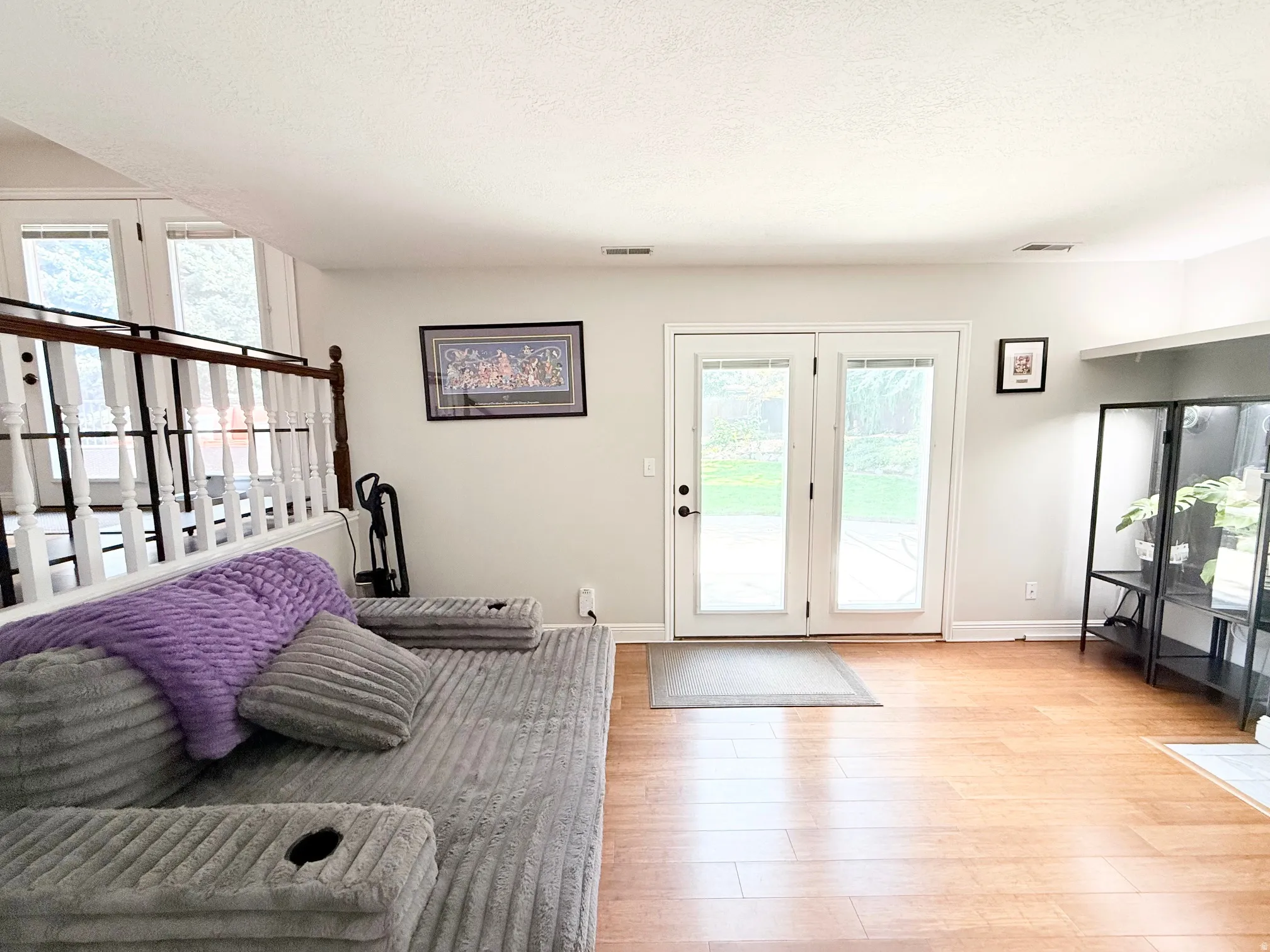 Wood-finish flooring throughout, white walls, and bright white ceiling