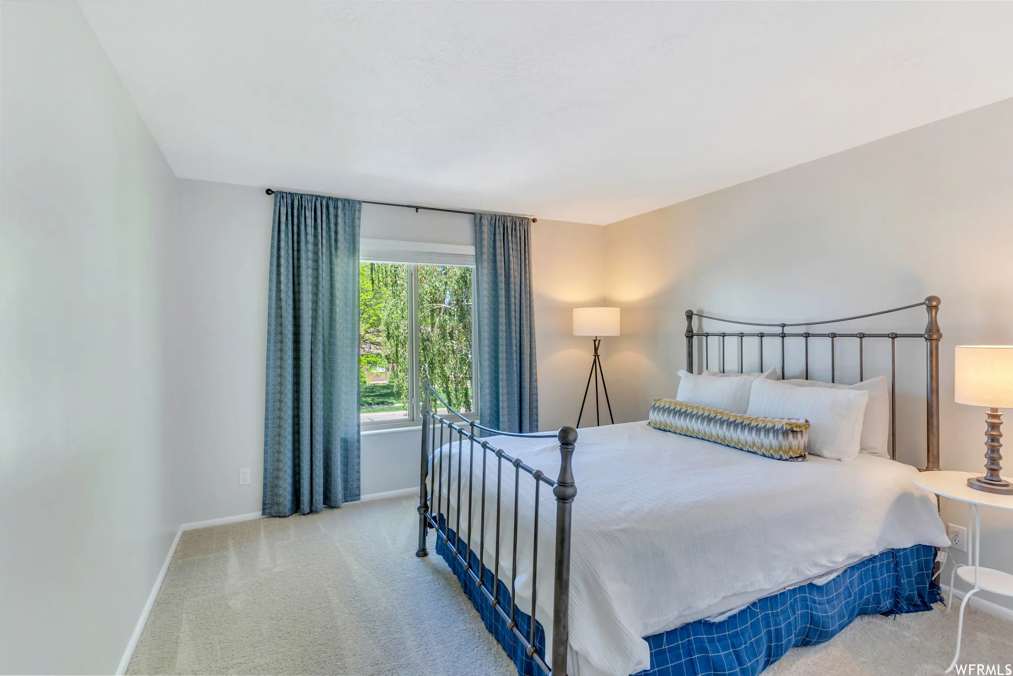 Recessed lighting, light-toned carpeting, ample natural light, and neutral wall tones