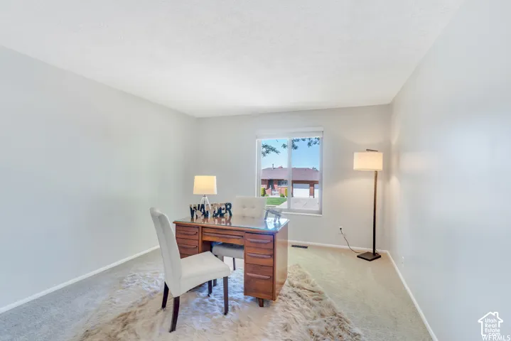Soft gray walls with light-toned carpeting