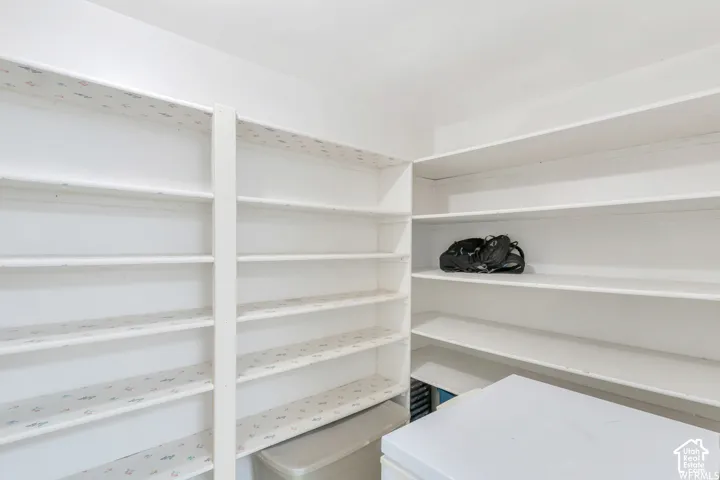 White shelving system with multiple tiers, offering extensive storage capacity