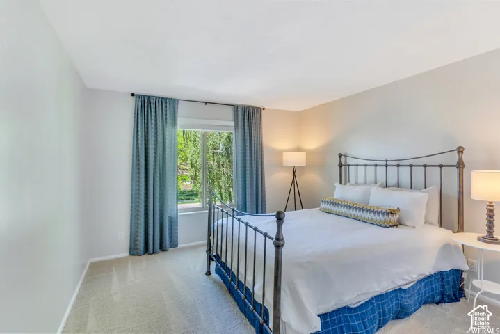 Recessed lighting, light-toned carpeting, ample natural light, and neutral wall tones