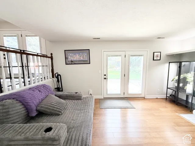 Wood-finish flooring throughout, white walls, and bright white ceiling