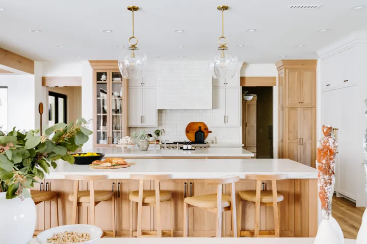 Kitchen featuring a large island with integrated cabinetry, recessed lighting, two pendant light fixtures, and a white subway tile backsplash