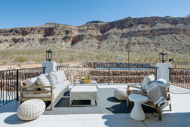 Spacious outdoor patio with a tiled surface and decorative metal railing