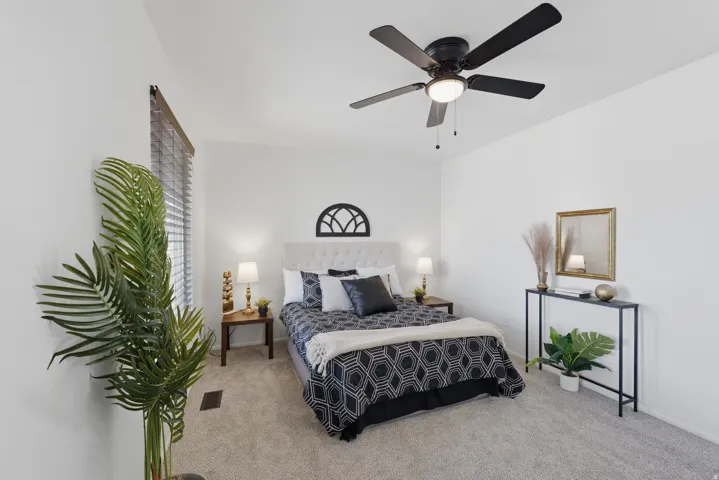 Wall-to-wall carpeting and a ceiling fan with integrated lighting