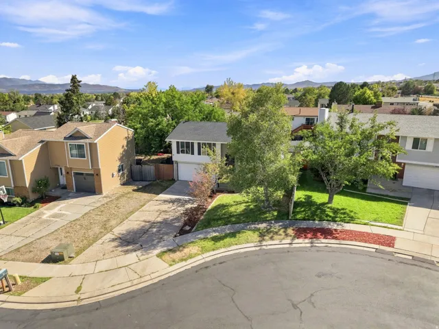 Residential property featuring a two-story structure, an attached garage, and a concrete driveway
