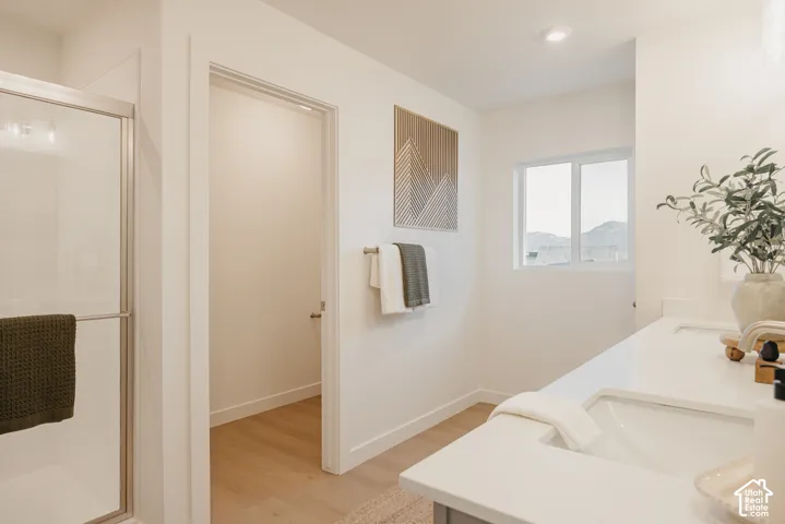 Primary Bath - This photo is of other similary floorplan. This specific home will have tub and shower seperate. Bright primary bedroom featuring wood-finish flooring, abundant natural light from dual windows, and direct access to a private ensuite bathr