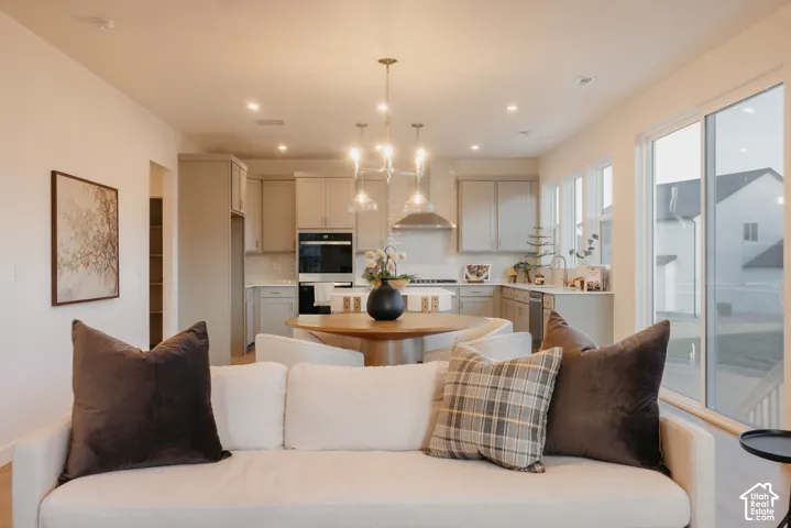 Open-concept living space with wood-finish flooring, recessed lighting, and a modern kitchen