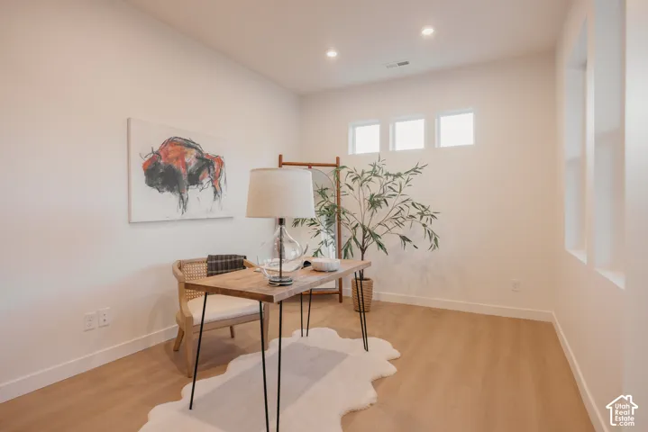 Recessed lighting, wood-finish flooring, and multiple windows