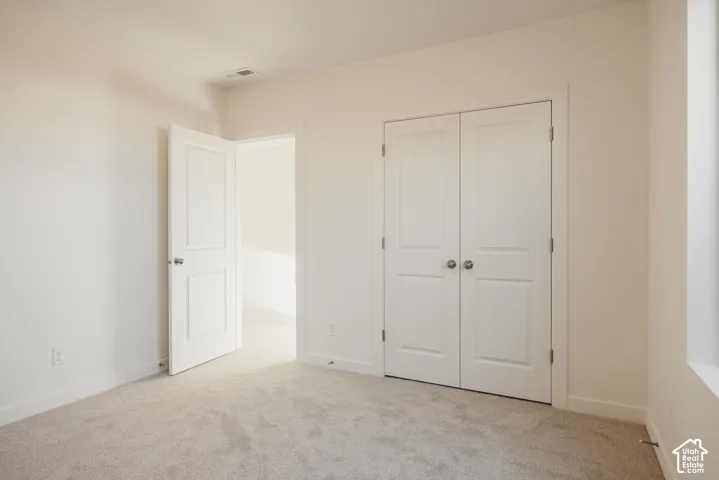 Bedroom 4 - Neutral-toned carpet flooring, white walls, and a window opening for natural light