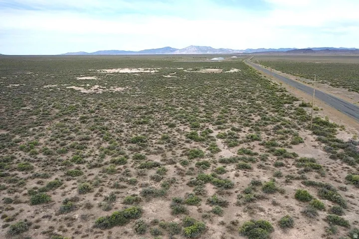 Expansive desert landscape with natural vegetation and distant mountain ranges