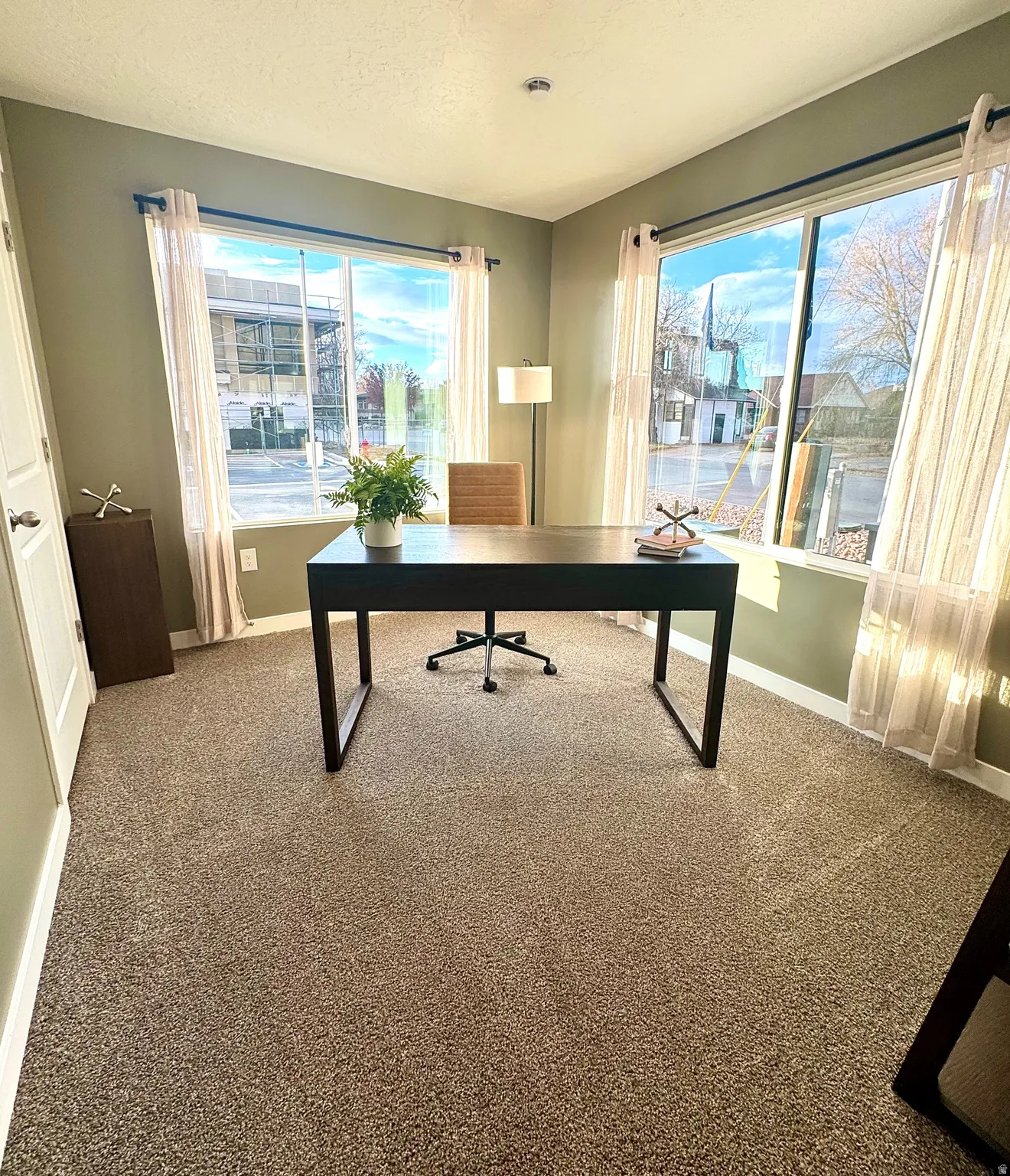 Recessed lighting, large windows, wall-to-wall carpeting, and a built-in closet