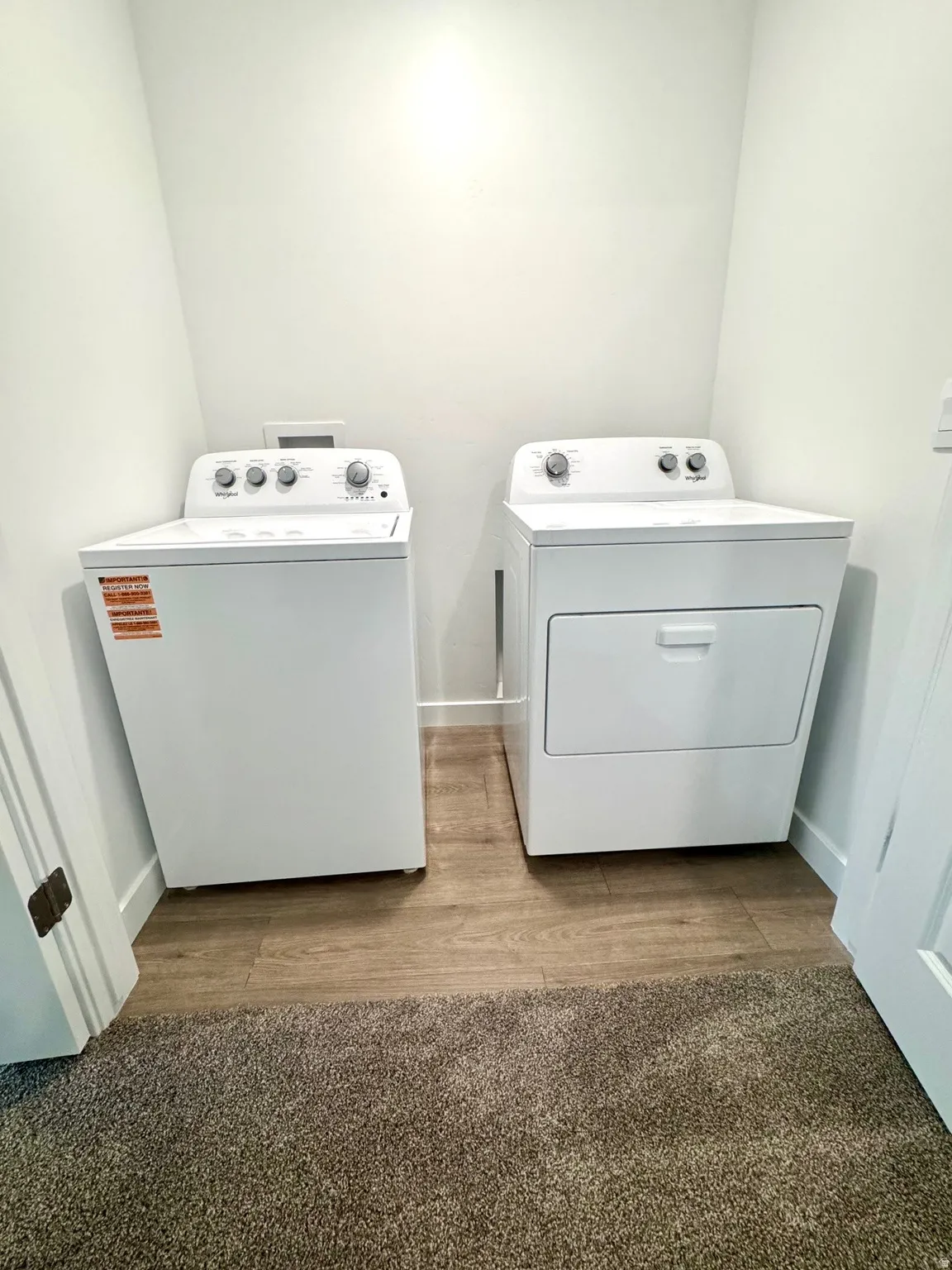 Dedicated laundry area featuring a white top-load washing machine and a white front-load dryer