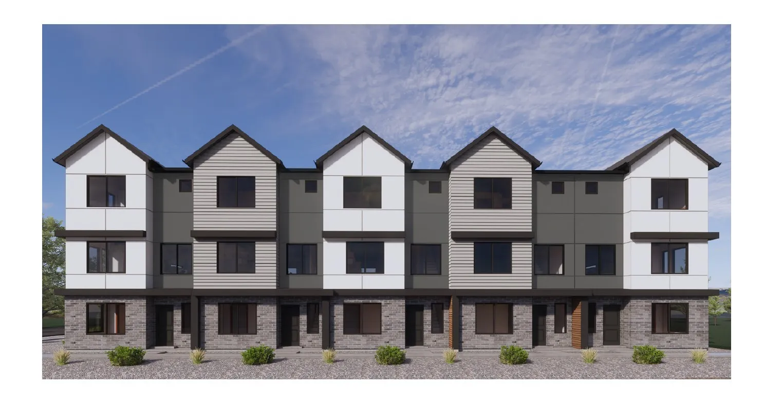 Multi-level townhome architecture featuring a stone and siding facade, accented by dark-framed windows and multiple gables