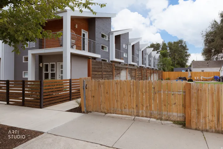 Modern multi-level exterior with a cantilevered roof design and horizontal siding