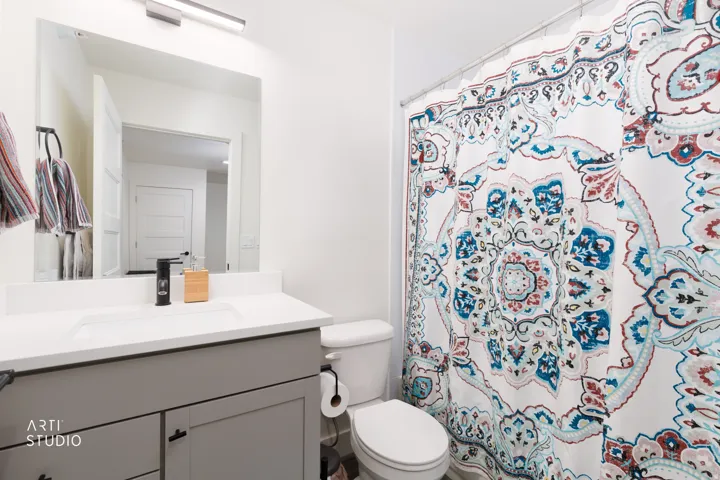Vanity with an integrated rectangular sink, large mirror, and overhead linear lighting