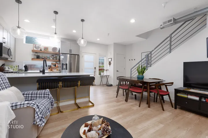 Open-concept living area with wood-finish flooring