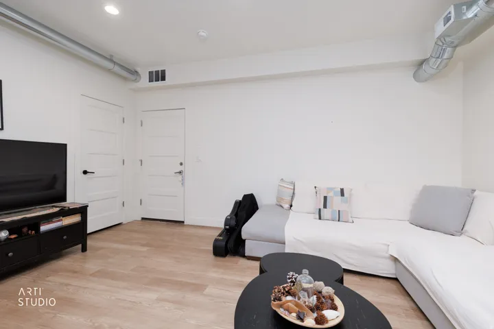 Recessed lighting, wood-finish flooring, white walls, and white paneled doors