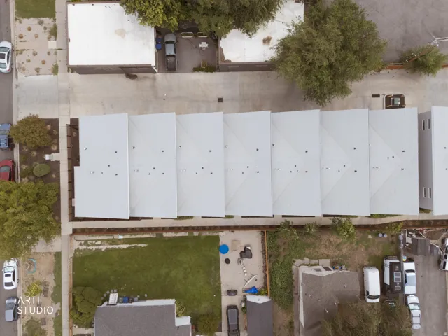 Row of properties featuring flat roofs and a concrete drive