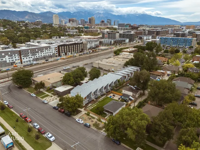 Mountain backdrop, urban skyline, and a commercial district