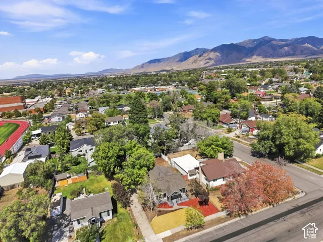 Aerial view showcasing this residential property situated on a tree-lined street within an established neighborhood