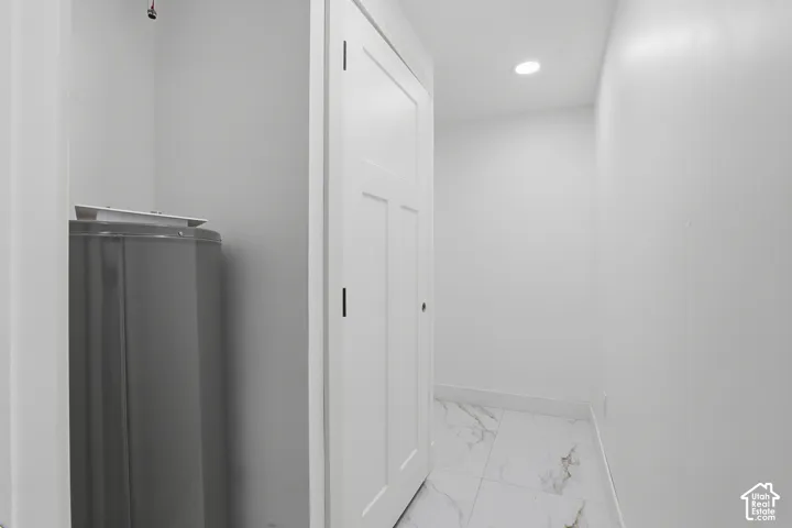 Recessed lighting, tile flooring, and a paneled interior door