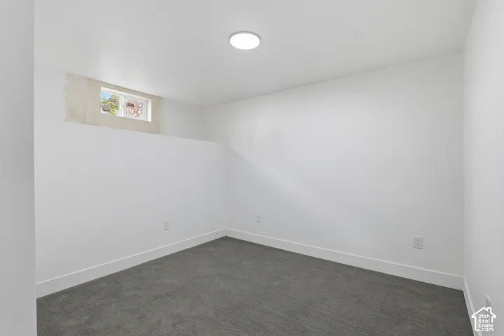 Recessed lighting, white walls, and gray carpeting