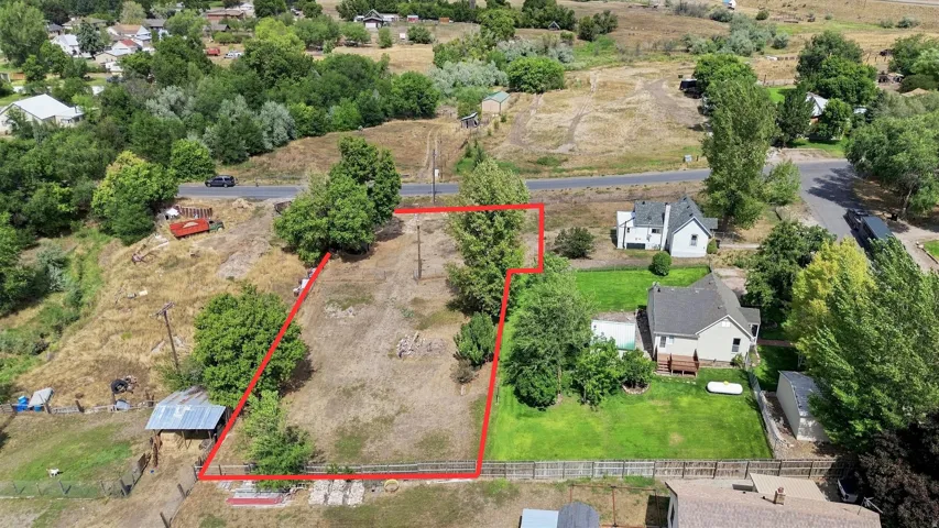 Expansive lot with mature trees and a sloped terrain