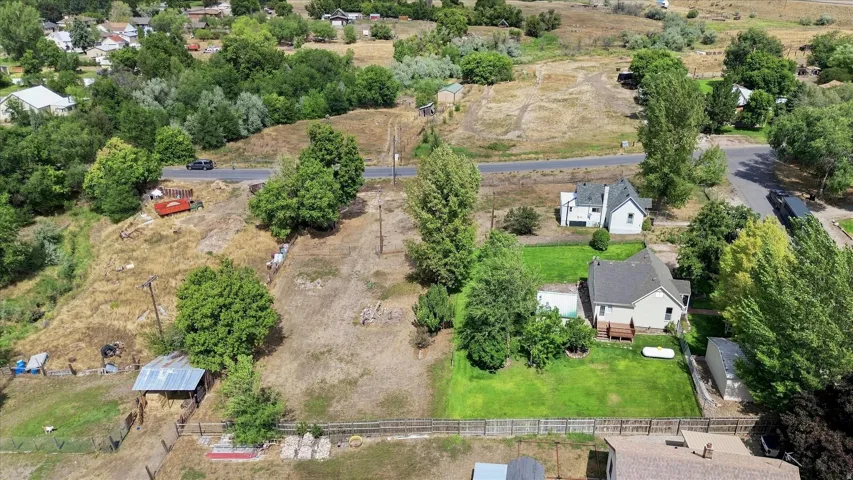 Residential property with established landscaping and a detached storage shed