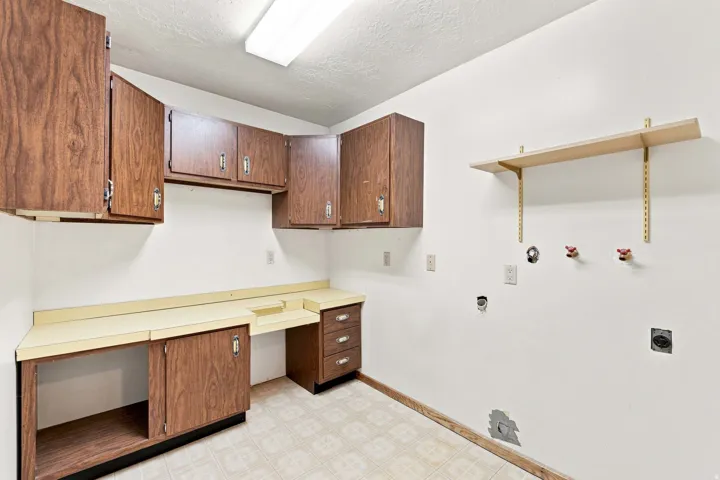 Built-in wood-finish cabinetry, integrated countertop, and tiled flooring