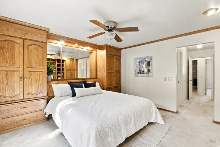Integrated wood-finish cabinetry with drawer storage and mirrored accents