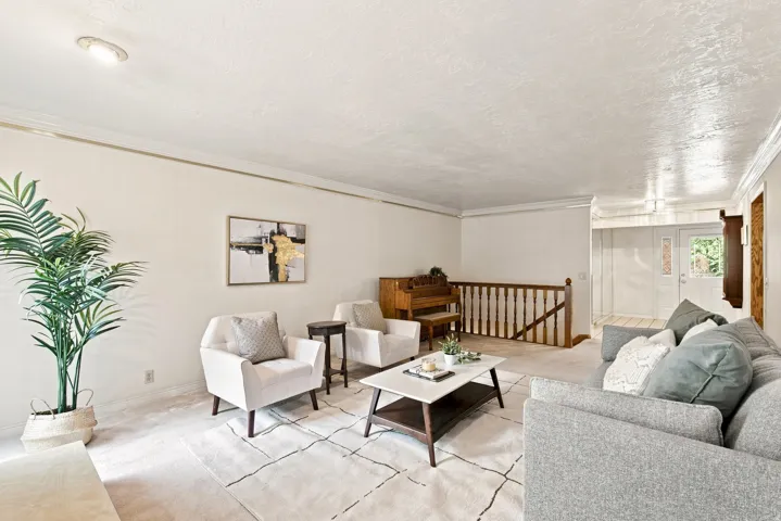Recessed ceiling lighting, crown molding, stairway with wood balusters, and a front entry door with decorative glass inserts