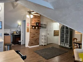 Exposed brick wall with small bedroom beyond