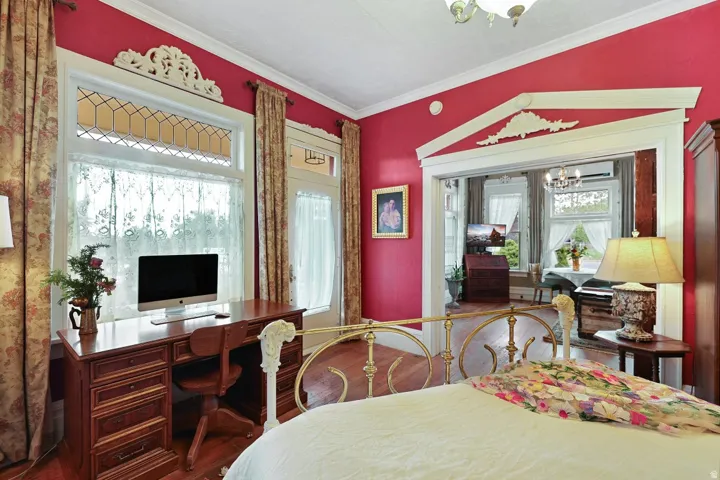 Bed room with office space and entrance to covered patio.