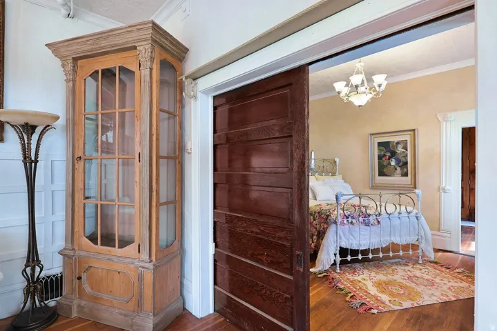 Large wooden panel door to bedroom