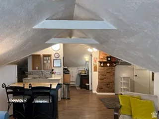 Sloped ceilings, exposed beams, and wood-finish flooring