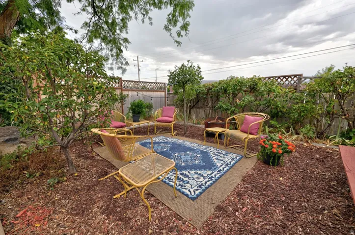 Large side yard with seating areas and picnic table
