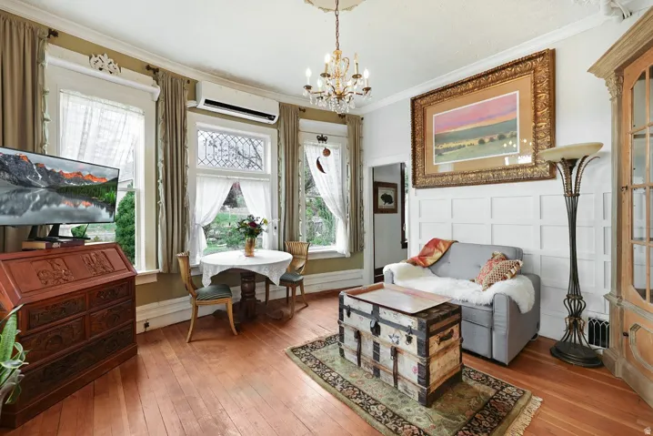 Cosy living room and dining, with 2 walls of windows looking out to the gardens